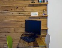 a computer sitting on top of a wooden desk